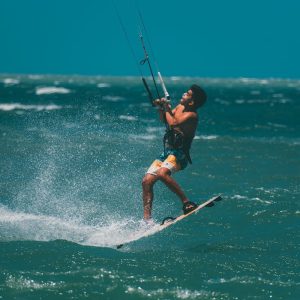 Young man enjoying an exhilarating kitesurfing experience on the open sea.